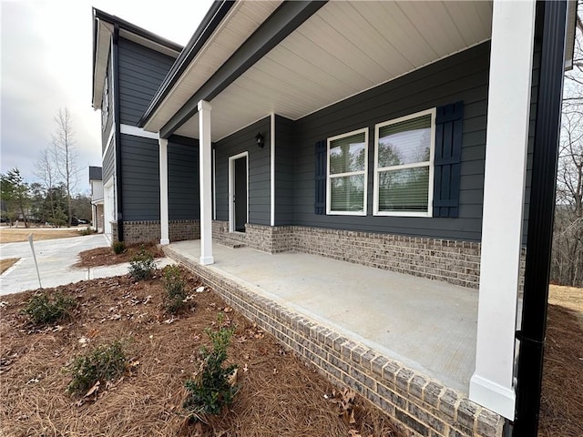 view of exterior entry with covered porch