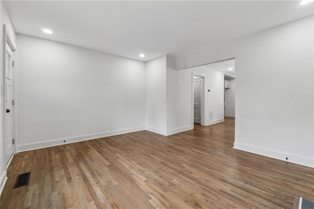 spare room with recessed lighting, visible vents, and wood finished floors
