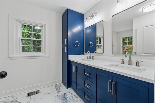 full bathroom featuring marble finish floor, a sink, double vanity, and visible vents