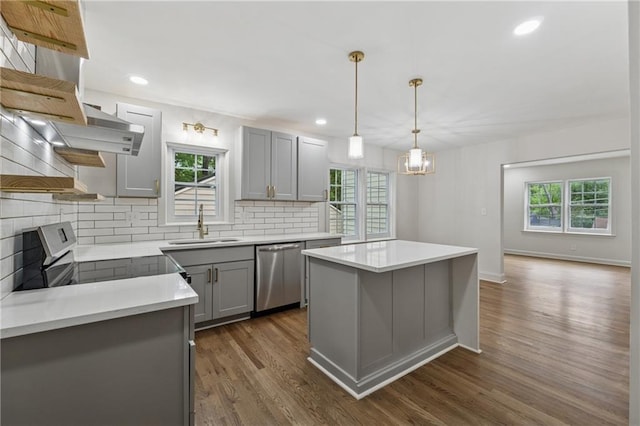 kitchen with open shelves, appliances with stainless steel finishes, gray cabinets, dark wood-style flooring, and backsplash
