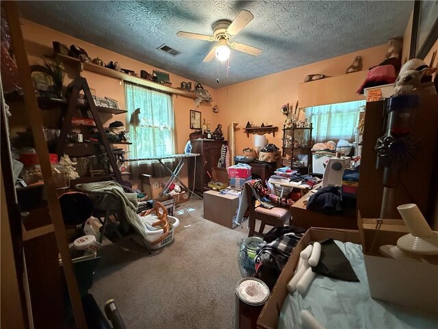 135 Woodcrest Dr, Covington, GA 30016 - carpeted home office with ceiling fan and a textured ceiling