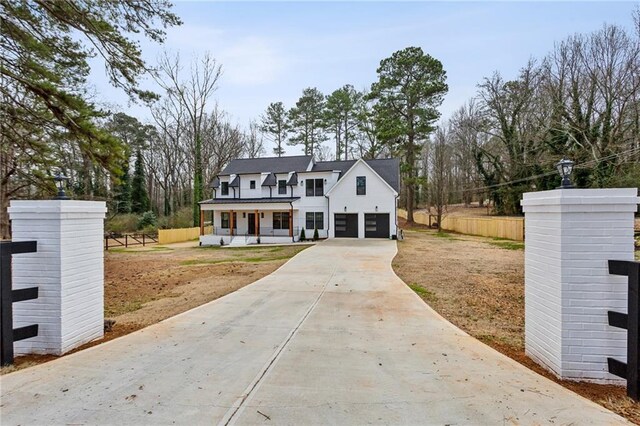 view of front of property featuring a porch and a garage