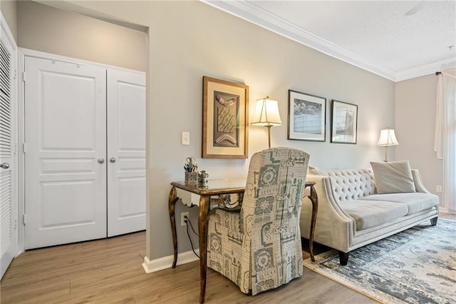 sitting room featuring light hardwood / wood-style floors and ornamental molding