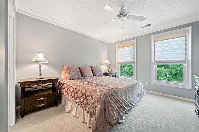 carpeted bedroom featuring ceiling fan, a textured ceiling, and ornamental molding