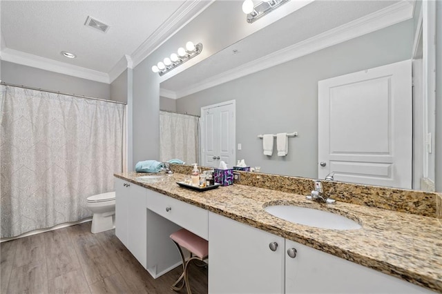 bathroom featuring hardwood / wood-style flooring, vanity, toilet, and crown molding