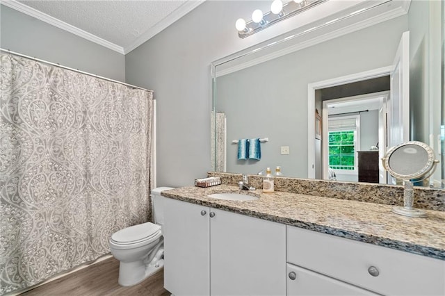 bathroom with hardwood / wood-style floors, a textured ceiling, toilet, vanity, and ornamental molding