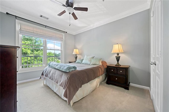 bedroom featuring ceiling fan, light carpet, and ornamental molding