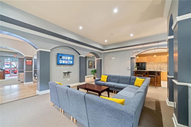 living room with light colored carpet and decorative columns