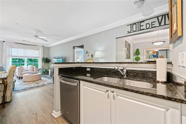 kitchen featuring sink, stainless steel dishwasher, light wood-type flooring, ornamental molding, and white cabinetry