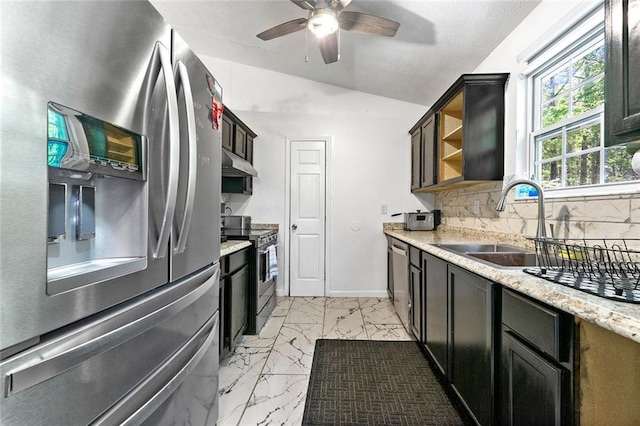 kitchen featuring stainless steel appliances, a sink, vaulted ceiling, open shelves, and under cabinet range hood