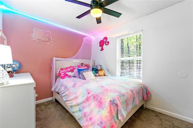 carpeted bedroom with vaulted ceiling, baseboards, and ceiling fan