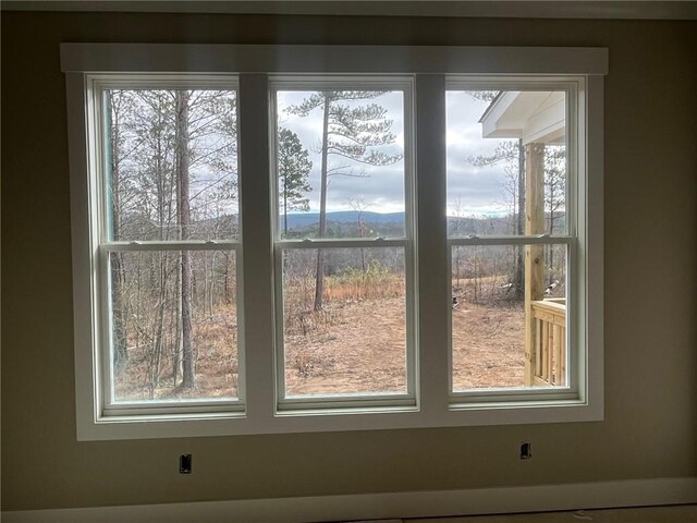 unfurnished living room with plenty of natural light, a fireplace, and high vaulted ceiling