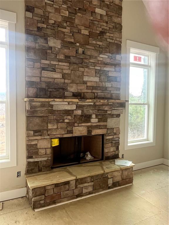 interior details with a stone fireplace