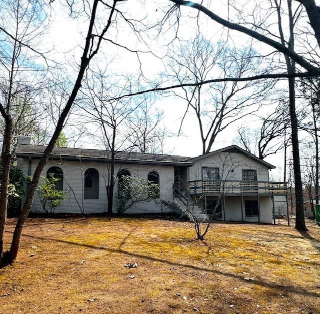 view of front of property featuring stairs and a deck