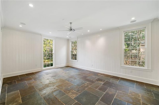 empty room featuring ceiling fan and ornamental molding