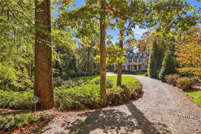 view of front of house with a front yard and a porch