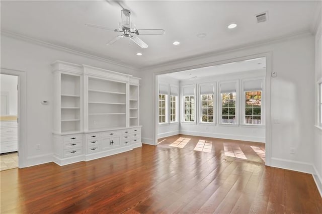 unfurnished living room with hardwood / wood-style floors, ornamental molding, and ceiling fan