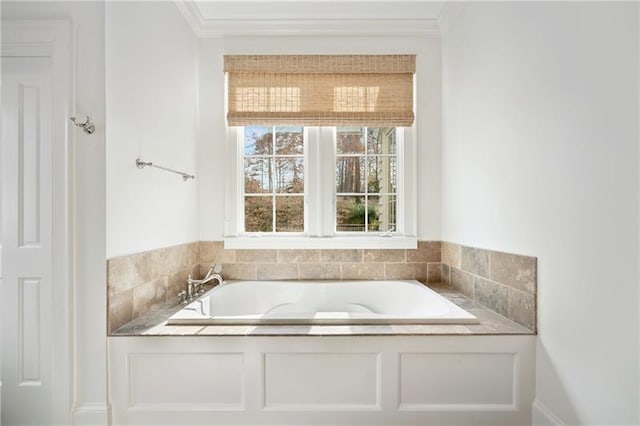 bathroom featuring ornamental molding and a bathing tub