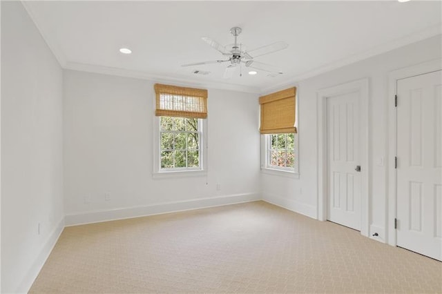 unfurnished bedroom featuring light carpet, crown molding, and ceiling fan