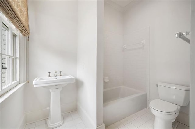 bathroom with tub / shower combination, tile patterned floors, and toilet