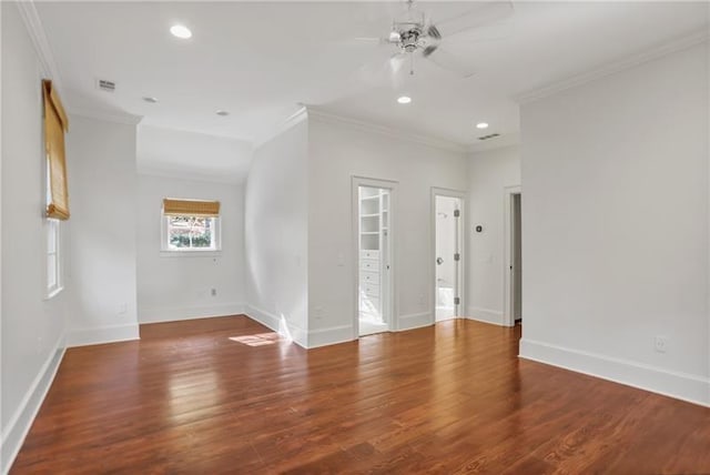 spare room featuring crown molding, dark hardwood / wood-style floors, and ceiling fan