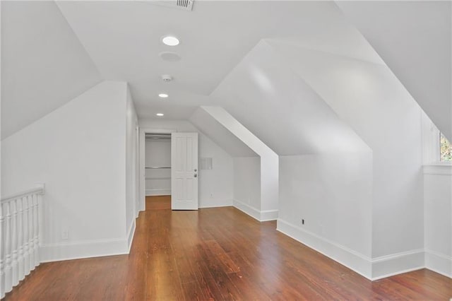 bonus room featuring lofted ceiling and dark hardwood / wood-style flooring