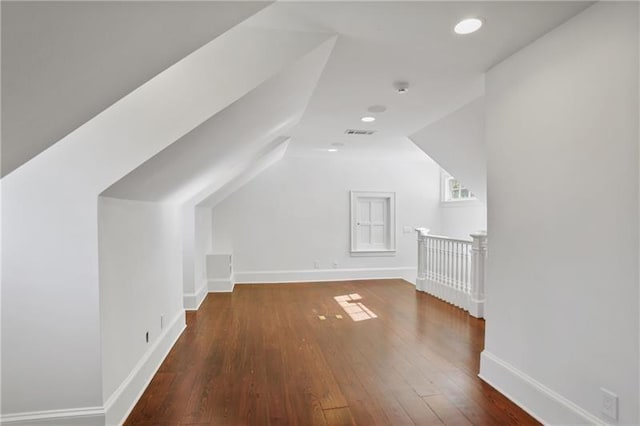 additional living space with dark hardwood / wood-style flooring and lofted ceiling