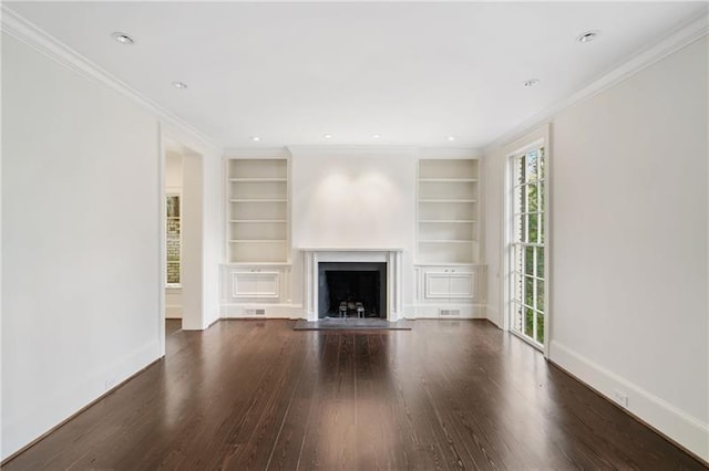 unfurnished living room with dark wood-type flooring, crown molding, and built in shelves