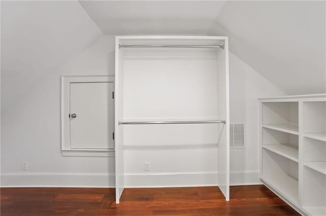 walk in closet featuring lofted ceiling and dark hardwood / wood-style flooring