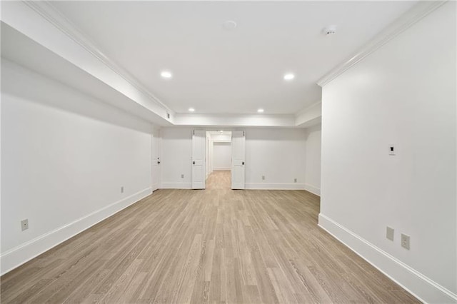 basement featuring crown molding and light wood-type flooring