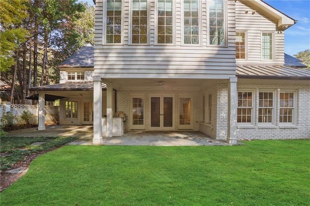 back of house featuring a yard and a patio