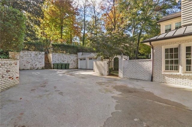 view of patio with an outbuilding and a garage