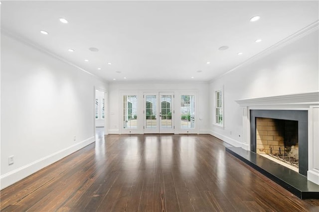 unfurnished living room featuring ornamental molding, dark wood-type flooring, and french doors