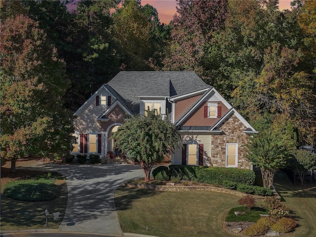 view of front of home featuring a lawn and a garage