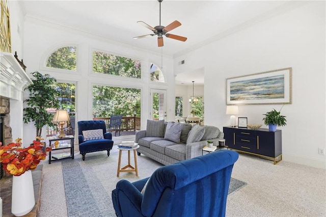 living room featuring a high ceiling, plenty of natural light, and ceiling fan