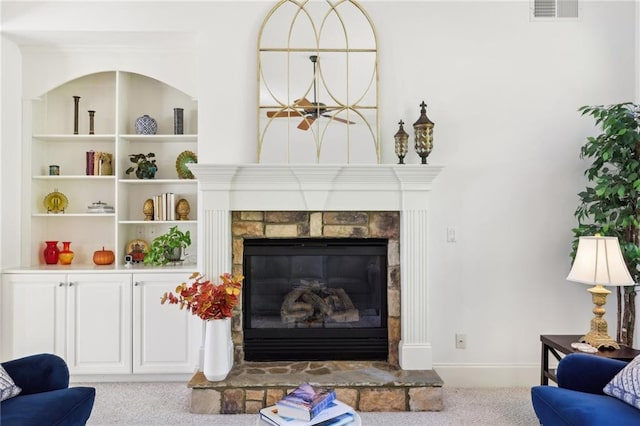 living room with a stone fireplace and light colored carpet