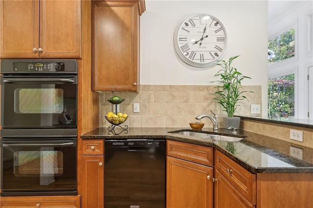 kitchen with dark stone countertops, backsplash, black appliances, and sink