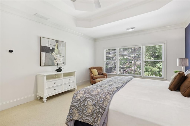 bedroom featuring ceiling fan, crown molding, light carpet, and a raised ceiling