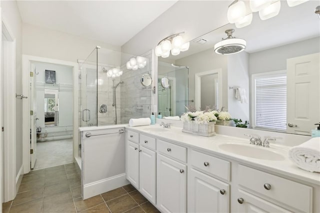 bathroom featuring vanity, a shower with shower door, and tile patterned floors