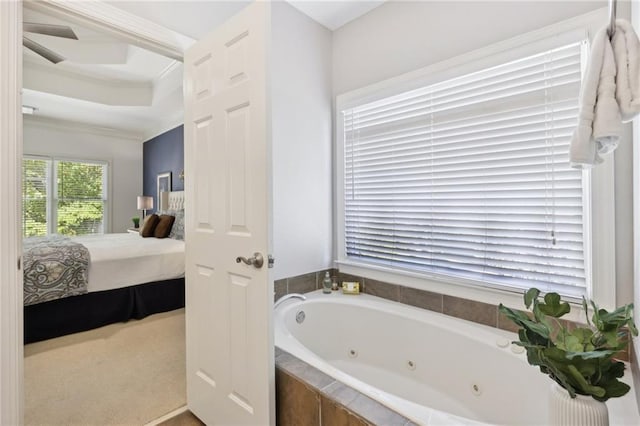 bathroom featuring ornamental molding and tiled bath