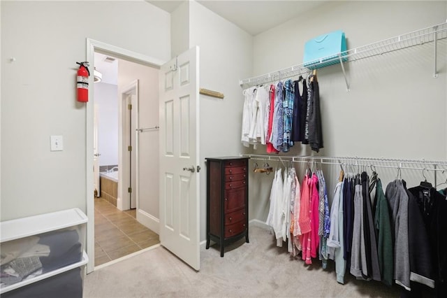 walk in closet featuring carpet