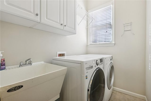 washroom featuring light tile patterned floors, cabinets, sink, and separate washer and dryer