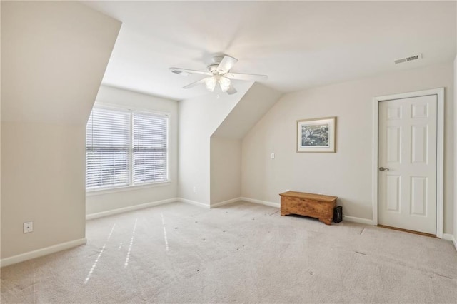 bonus room featuring ceiling fan, vaulted ceiling, and light colored carpet