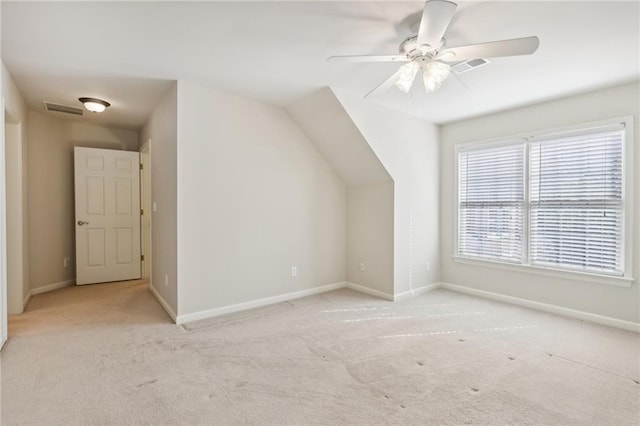 bonus room with ceiling fan, light carpet, and lofted ceiling