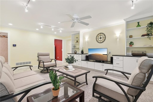 carpeted living room with crown molding and ceiling fan