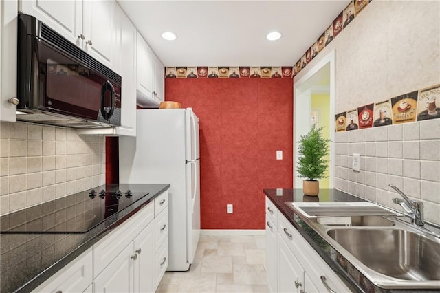 kitchen with white cabinetry, tasteful backsplash, black appliances, and sink