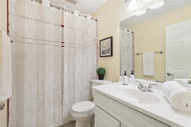 bathroom featuring vanity, a shower with shower curtain, and toilet