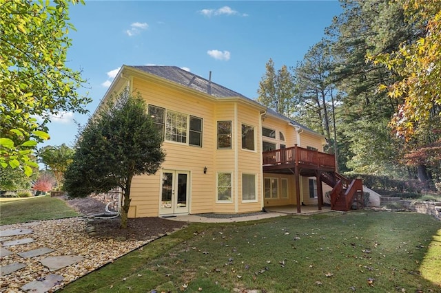 rear view of property with a patio, a deck, and a lawn