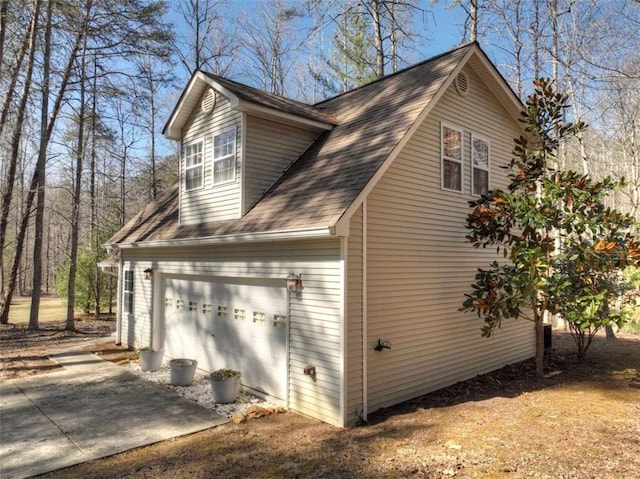 view of side of home featuring a shingled roof