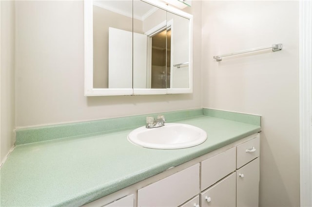 bathroom with vanity and ornamental molding